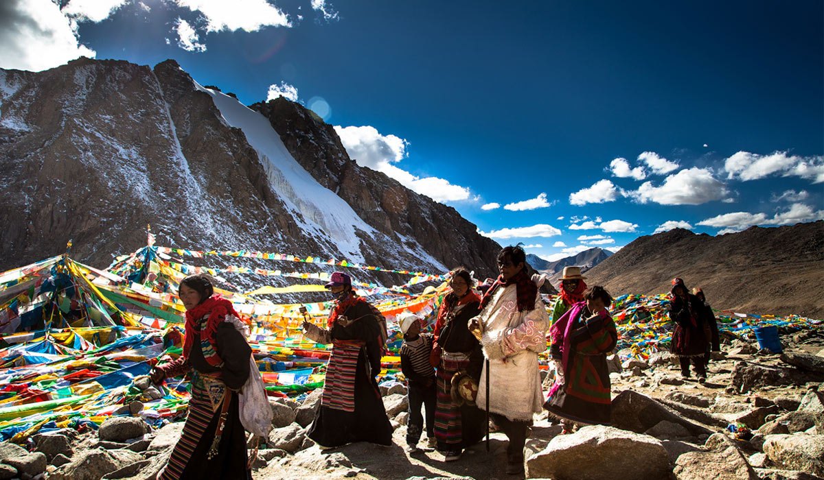 tibetan pilgrims walk the kora around mountain kailash