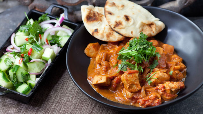 Chicken tikka masala with minted cucumber salad and naan bread