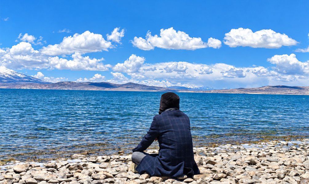 Traveler meditating on the shore of sacred Lake Manasarovar