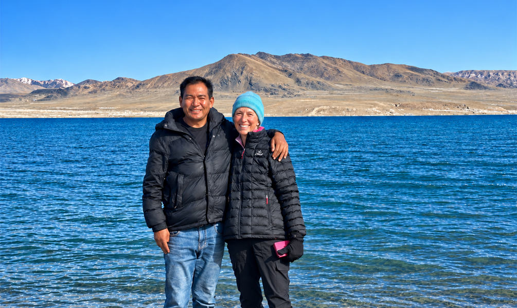 Tibet Vista guest with local guide by a plateau lake in Ngari Tibet