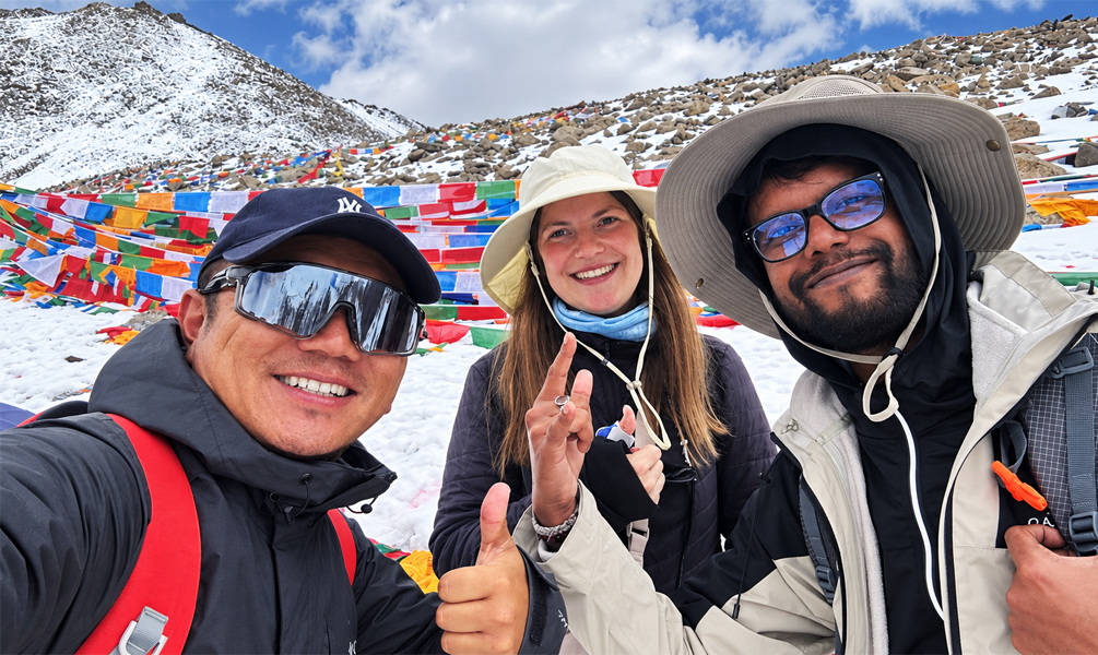 Travelers and Tibetan guide at Dolma La Pass during Mount Kailash Kora