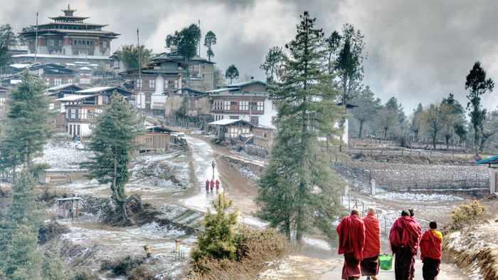Lamas carrying life necessities to Gangtey Monastery wearing slippers in January