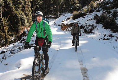 Mountain biking on snowy road