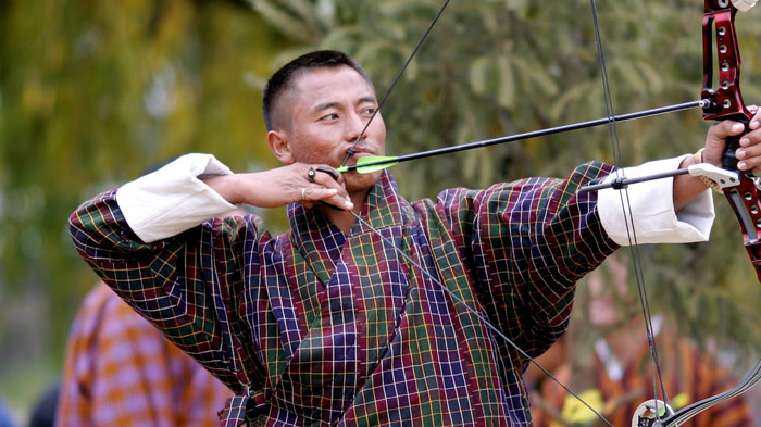 A Bhutanese Archer is displaying his superb archery skills