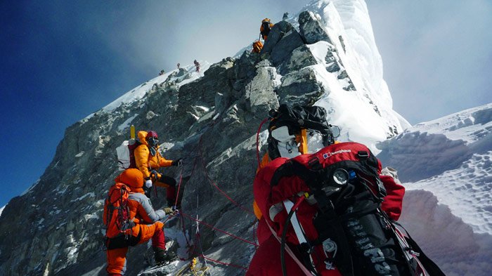 crowds of mountaineers on hillary step on mount everest