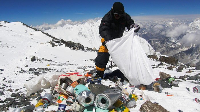 used oxygen bottles and other trash on mount everest
