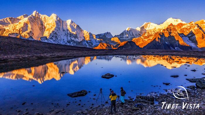 Mount Everest and the three Himalayan giants shimmer in golden light in Gama Valley