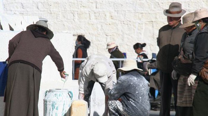 Walls are painted during Lhabab Duchen Festival.