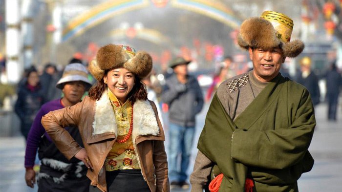 well-dressed tibetans visit monasteries and friends