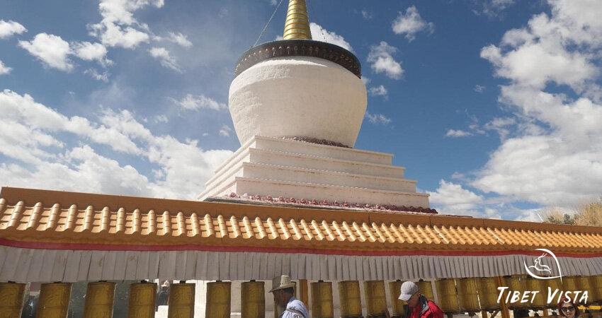 Local Tibetans walk clockwise around the white sutpa for pilgrimage