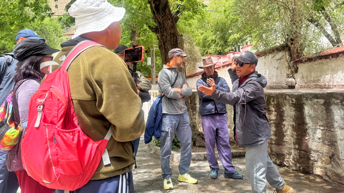 Our local guide explains the meaning behind the hand gestures used in Tibetan monk debate