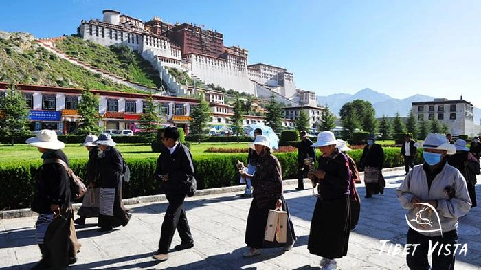 Locals Tibetan are walking the kora around the Potala Palace