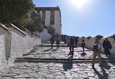 Tourists are ascending the white palace of Potala Palace
