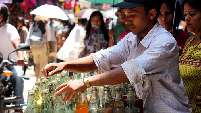 A vendor sells soda to locals.