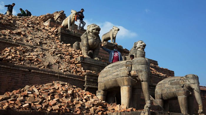 Tourists ascend the damaged site of Nyatapola temple in Bhaktapur city