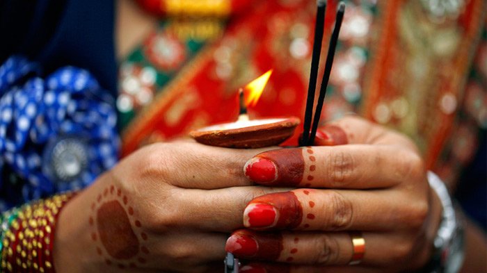 Lighting oil lamps during Teej Festival