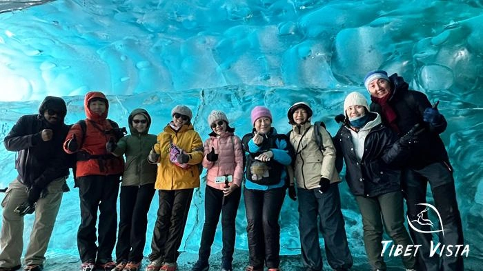 Our guests explore the amazing blue ice caves of Laigu Glaciers