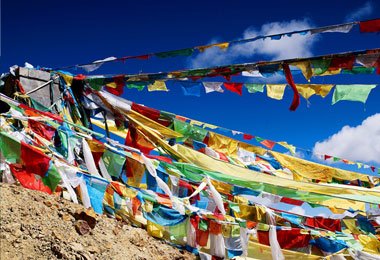 Prayer flags at Mila Mountain Pass for increasing happiness and good fortune among all living beings.