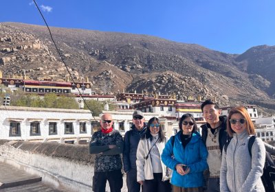 Traveler photo: Our guests stand side by side at the entrance of Drepung Monastery, taking a meaningful group photo. (April 2026)