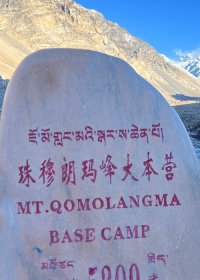 Traveler photo: Beside the Everest Base Camp monument, a guest faces the camera as the 8,848-meter peak stands silently behind. (April 2026)