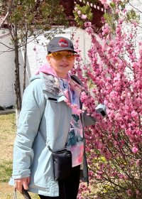 Traveler photo: A guest poses happily beneath Lhasa's pink peach blossoms, their smile even brighter than the flowers. (April 2026)