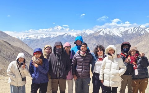 Traveler photo:  Guests chat and laugh at Gawula Pass, with the rolling Himalayan snow mountains behind them.  (April 2026)