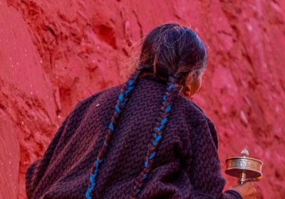 Traveler photo: Local resident is turning prayer wheels to pray for blessings. (April 2025)
