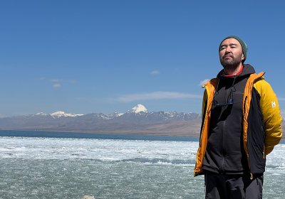 Traveler photo: Our guest takes pictures with Mount Kailash along the shore of Lake Manasarovar. (April 2026)	