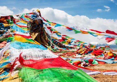 Traveler photo: Colorful Tibetan praying flags fluttering in the wind. (April 2025)
