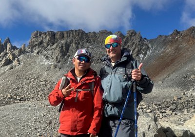 Traveler photo: On the kora trail, the guest and guide take a photo together, marking their shared pilgrimage journey. (August 2026)