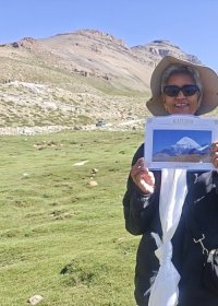 Traveler photo: A guest holds a commemorative certificate in front of Mount Kailash, taking a meaningful photo with the sacred peak. (August 2026)