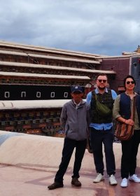Traveler photo: Guests pose for a relaxed group photo on the open square before the temple, with the building in the background. (August 2026)