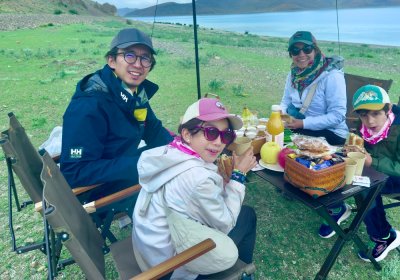 Traveler photo: Guests pause in the Tibetan landscape, unpacking a simple picnic on the meadow—a moment of pure joy. (August 2026)