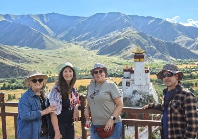 Traveler photo: Guests lean on the railing at a Shigatse viewing platform, taking in the vast plateau landscape. (August 2026)