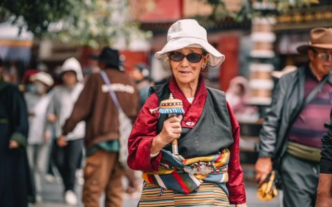 Traveler photo: Pilgrims on Barkhor Street hold prayer wheels as they perform the kora. (August 2025)