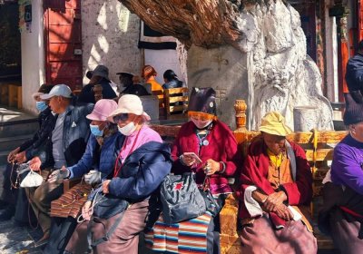 Traveler photo: Locals savor slow moments under Barkhor Street's shady trees. (August 2025)