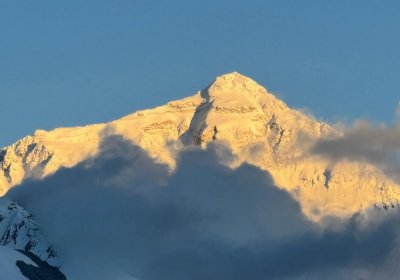 Traveler photo: As the sun set, a golden glow bathed the summit of Mount Everest, turning its icy peak into a crown of light. (August 2025)