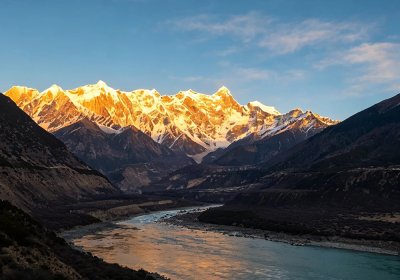 Traveler photo: Sunset casts a golden glow over the summit of Mount Namcha Barwa, the highest mountain in eastern Tibet. (August 2026)	