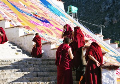 Traveler photo: Tibetan monks in red robes are celebrating the Shoton festival at Drepung monastery and preparing for the giant Thangka unveiling ceremony. (August 2026)	