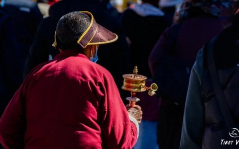 Traveler photo: On the Barkhor Street pilgrimage circuit in Lhasa, Tibet, we captured a local Tibetan slowly walking while rotating a prayer wheel. (December 2025)