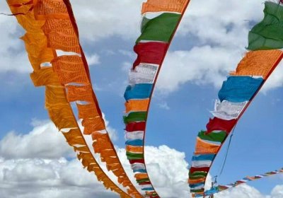 Traveler photo: Tibetan prayer flags snap in the plateau wind, each flag cloth imprinted with sacred scriptures and symbols. (December 2025)