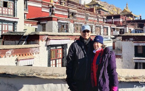 Traveler photo: On the white steps of temple in Lhasa, Tibet, our couple of guests smile at each other, documenting romantic moments. (December 2025)
