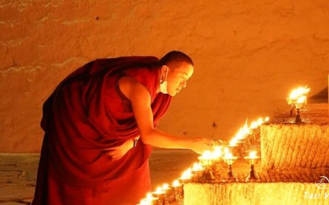 Traveler photo: Tibetan monk lights the butter lamp inside the monastery, praying the blessing for all the beings. (December 2025)	