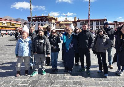 Traveler photo: On stone-paved roads of Barkhor Street in Lhasa City, Tibet, guests leave joyful commemorative photos in the ancient neighborhood. (February 2026)