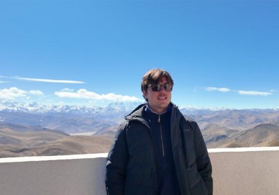 Traveler photo: At Gawula Pass viewing platform in Shigatse, Tibet, one of our guests takes commemorative photos with Himalayan snow mountain range as backdrop. (February 2026)