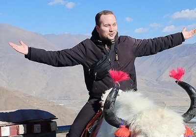 Traveler photo: By Yamdrok Lake in Shannan, one of our guests experiences riding a gentle yak. (February 2026)