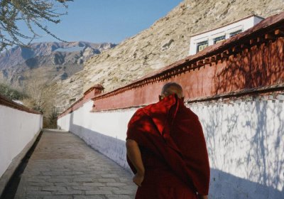 Traveler photo: In corridors of Sera Monastery in Lhasa, Tibet, we captured a red-robed monk slowly walking with scriptures in hand. (February 2026)