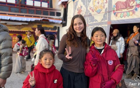 Traveler photo: Our beloved guest take pictures with Tibetans kids during the exploration of Tibetan monasteries. (February 2026)	