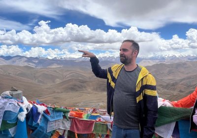 Traveler photo: Wind tangles hair at Gawula Pass, but guests’ smiles are as clear as the snow peaks behind them. (July 2026)