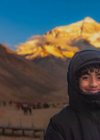 Traveler photo: A guest stands at the foot of Mount Everest, capturing a precious photo with the world's highest peak. (July 2026)